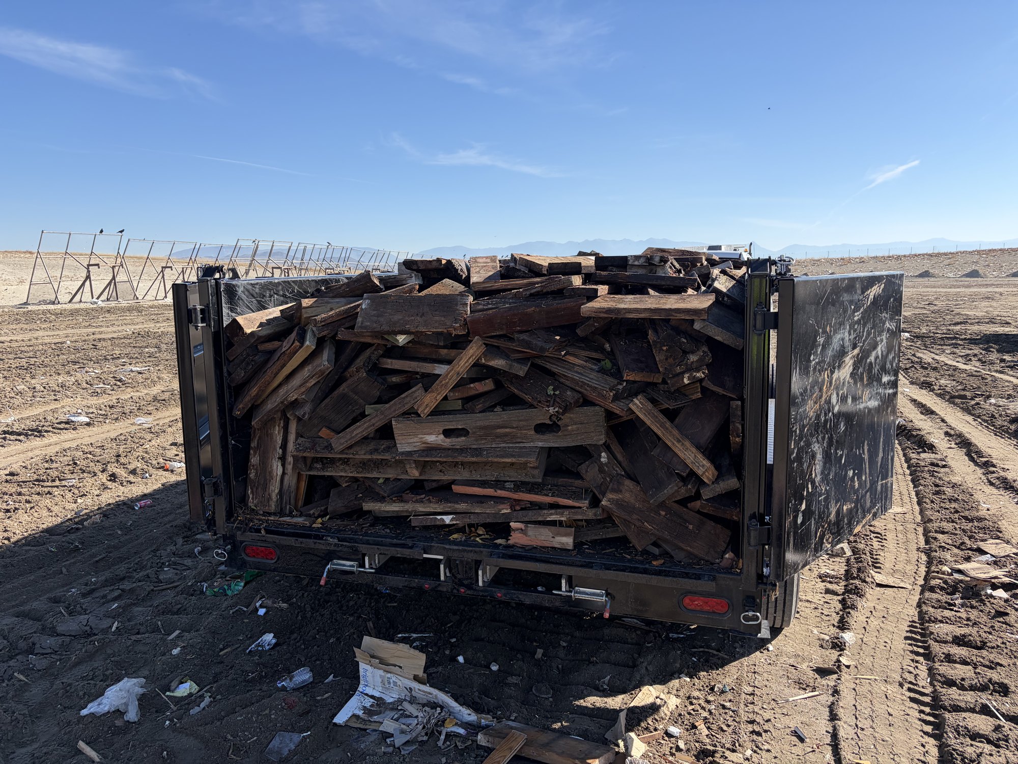 Dump trailer loaded with stacked decking boards