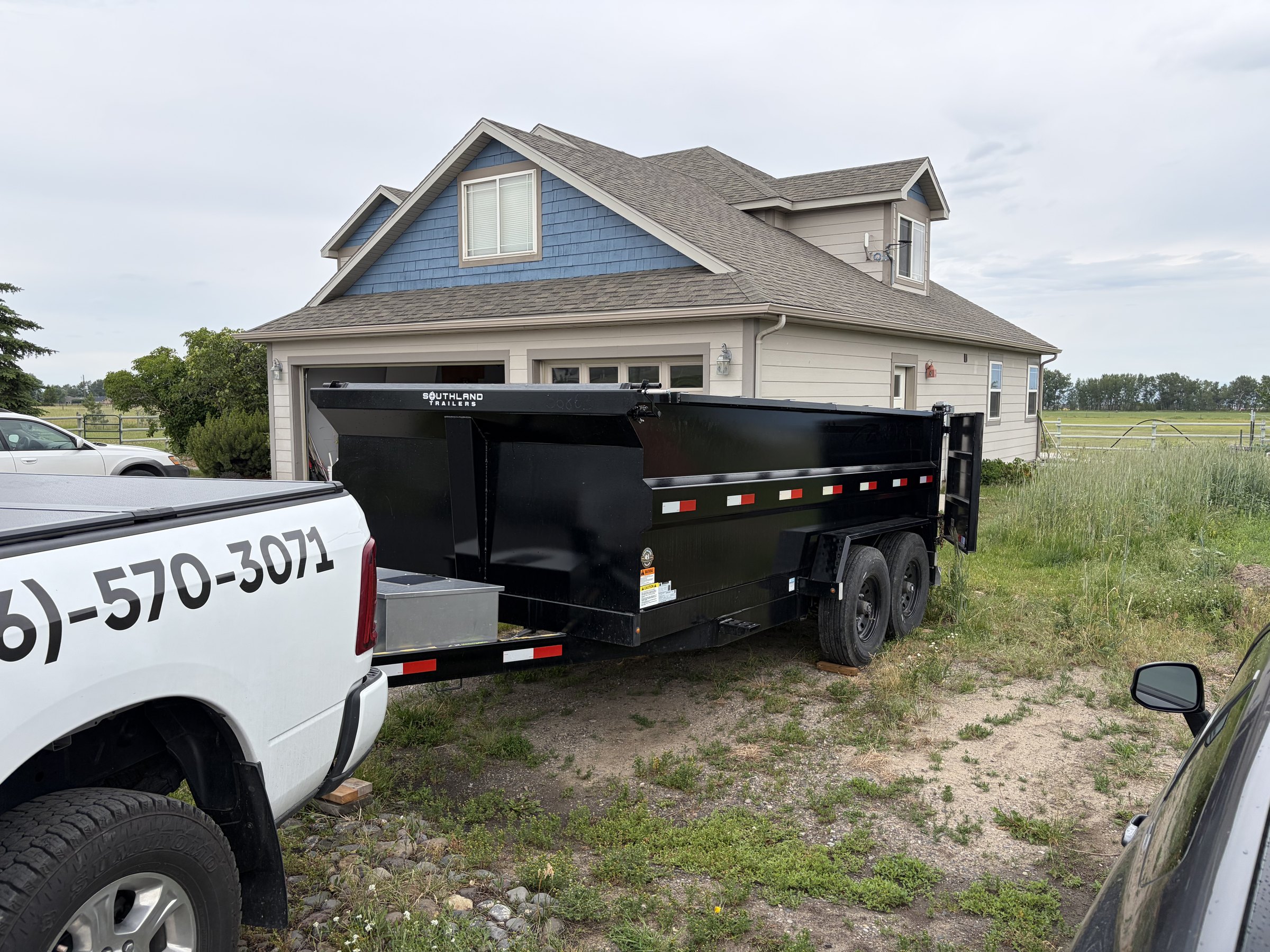 Dump trailer dropped at a snowy ranch for pickup