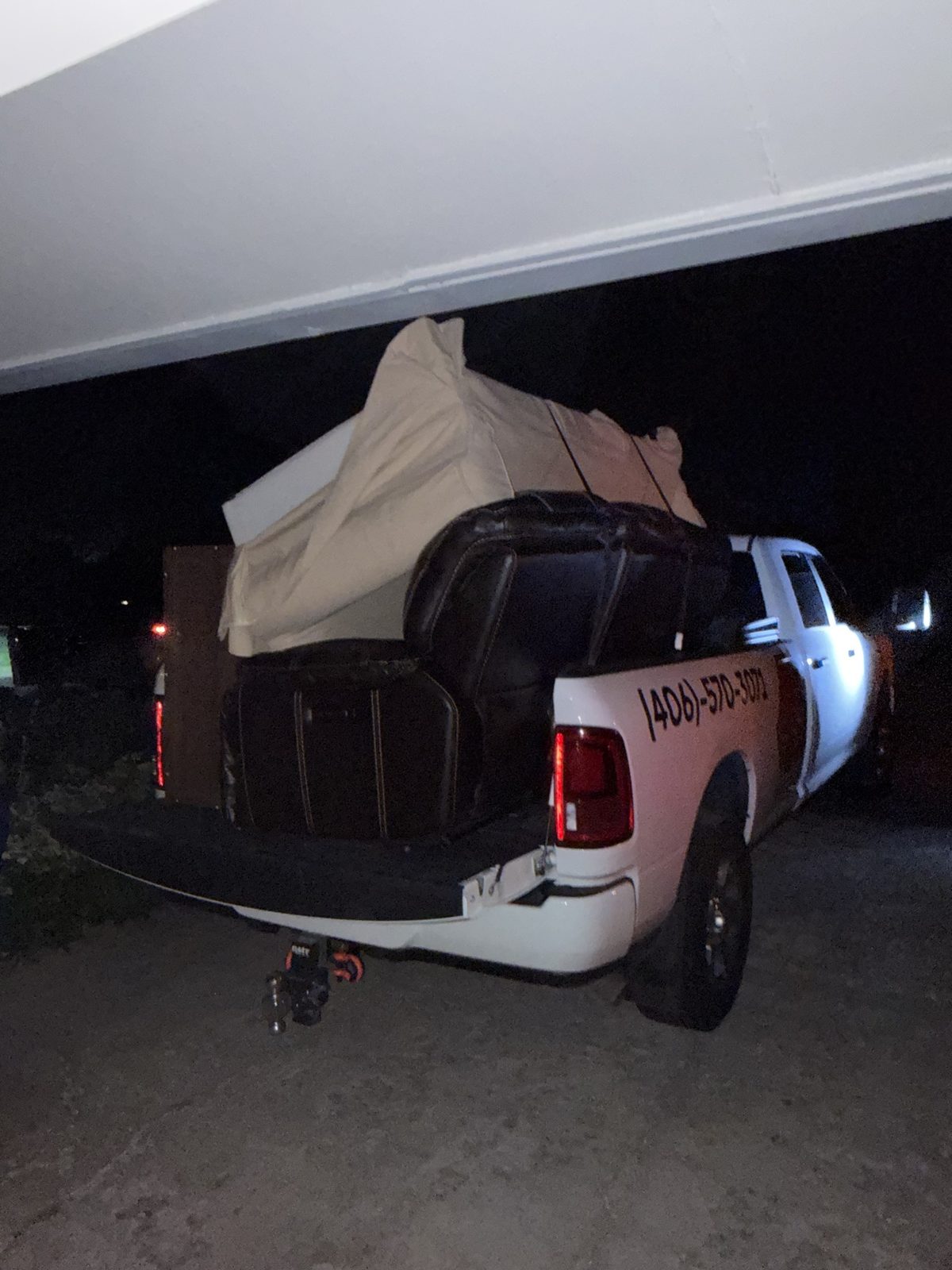 Leather chairs and a wrapped mattress loaded in the JACKD truck