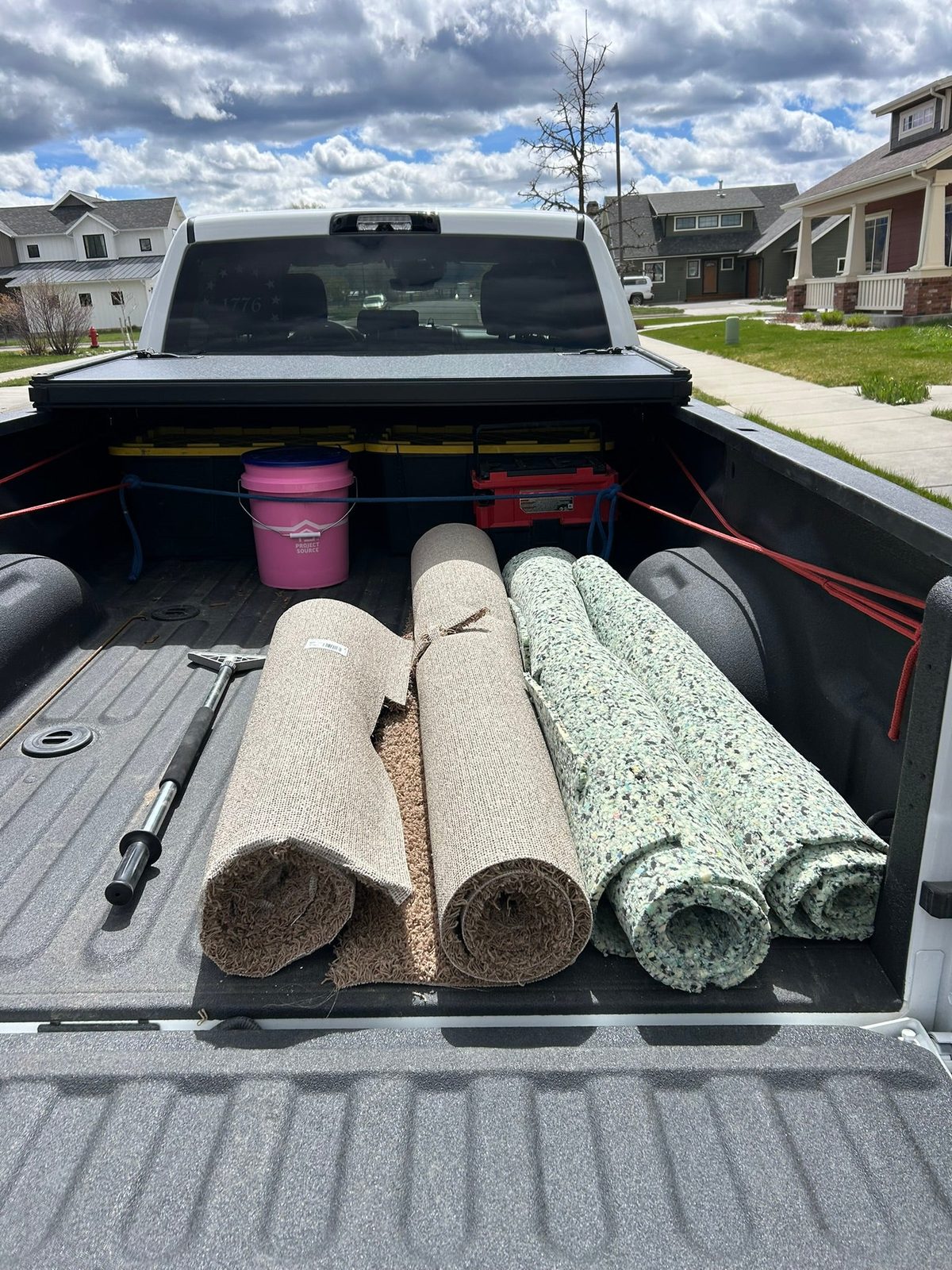 Rolled carpet loaded in the bed of a pickup