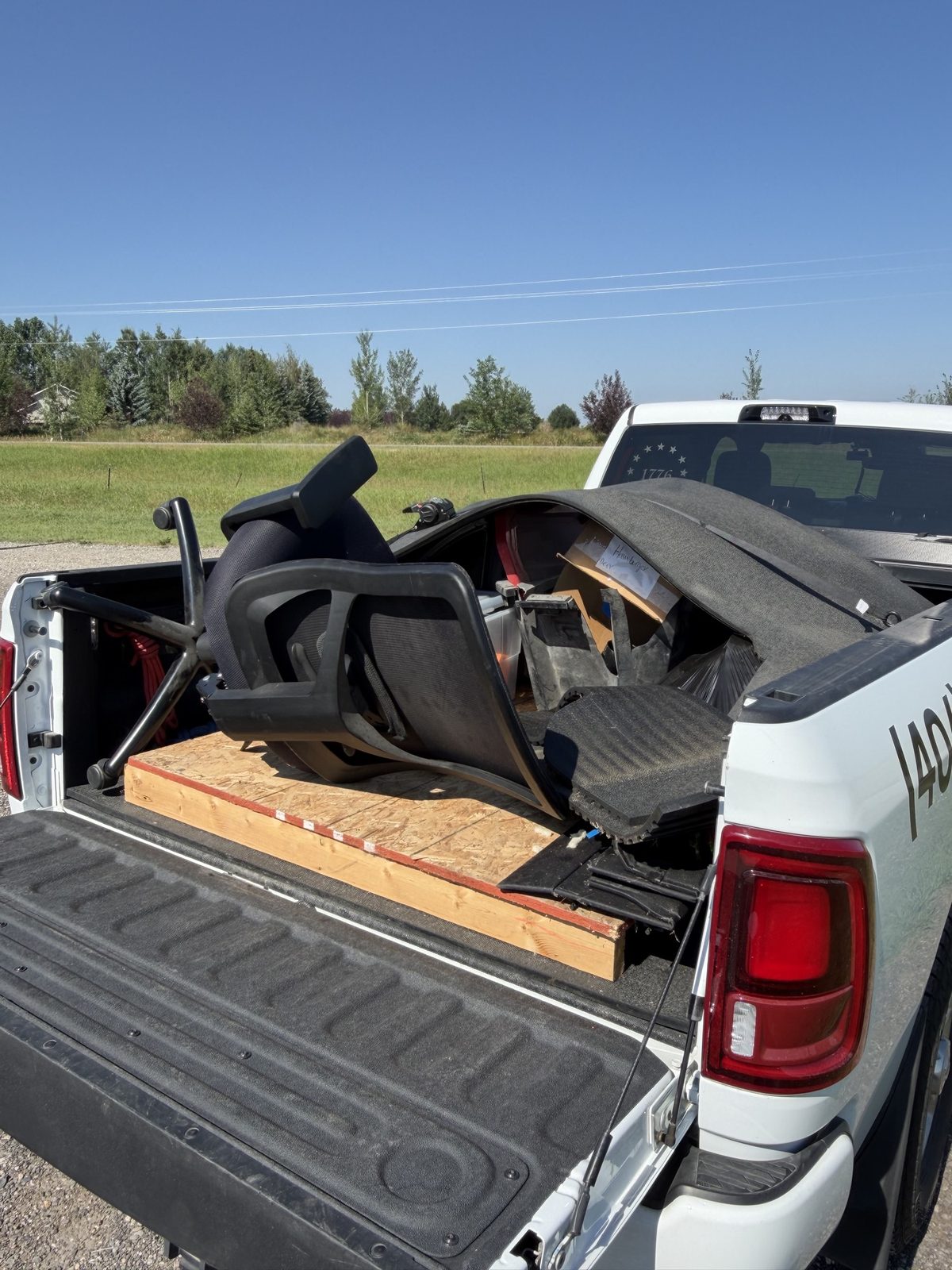 Office chairs and debris loaded in the JACKD truck bed