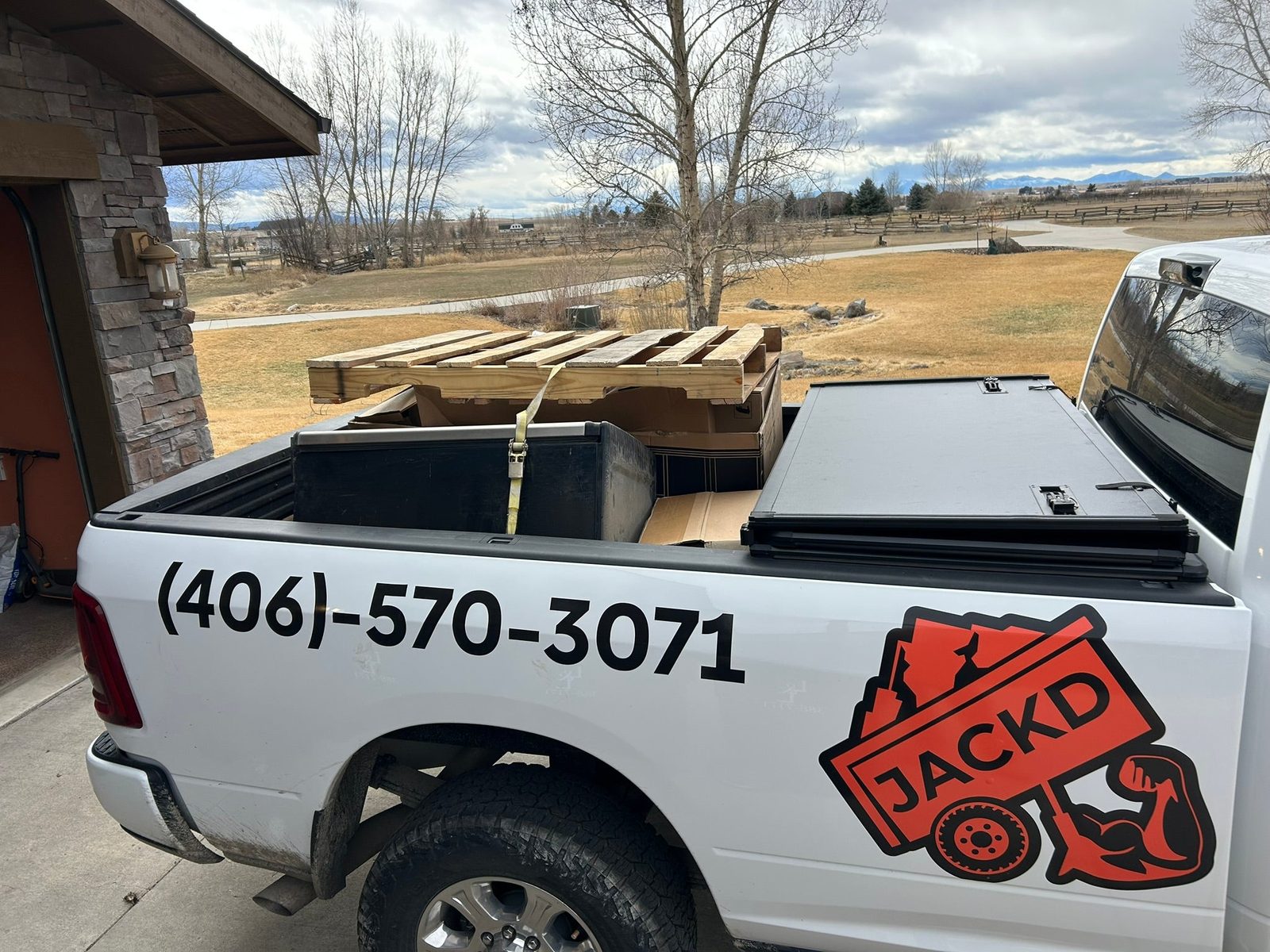 JACKD truck on a snowy Montana road with a small load