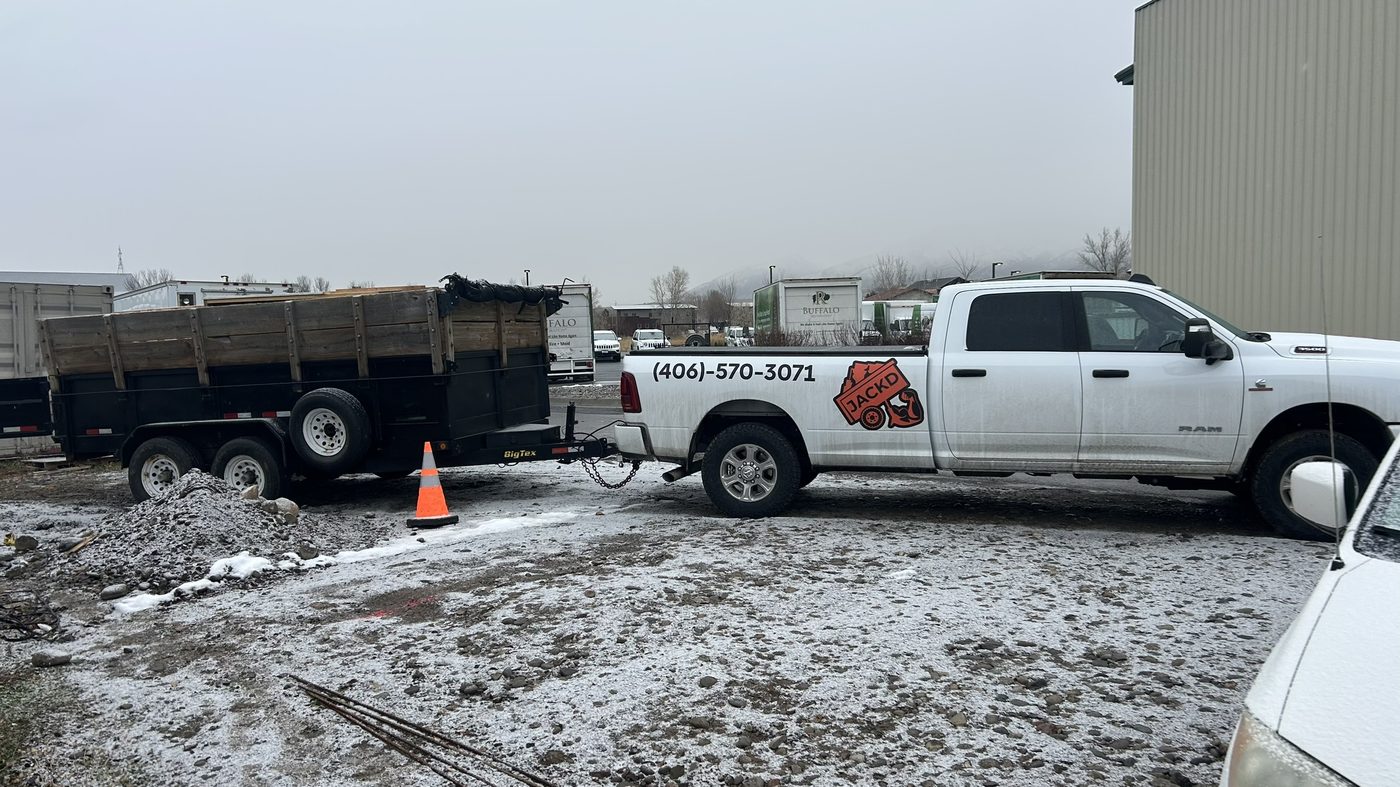 Dump trailer being moved at a Bozeman job site