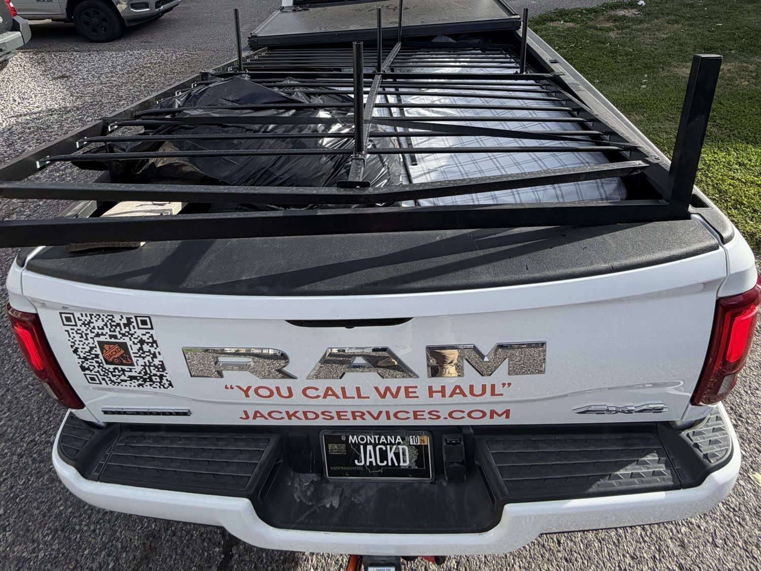 JACKD Ram tailgate with You call, we haul and jackdservices.com